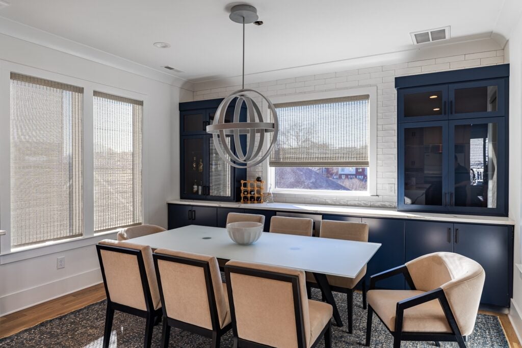 Woven wood shades in a dining room adding natural texture and filtered light for a coastal Carolina home