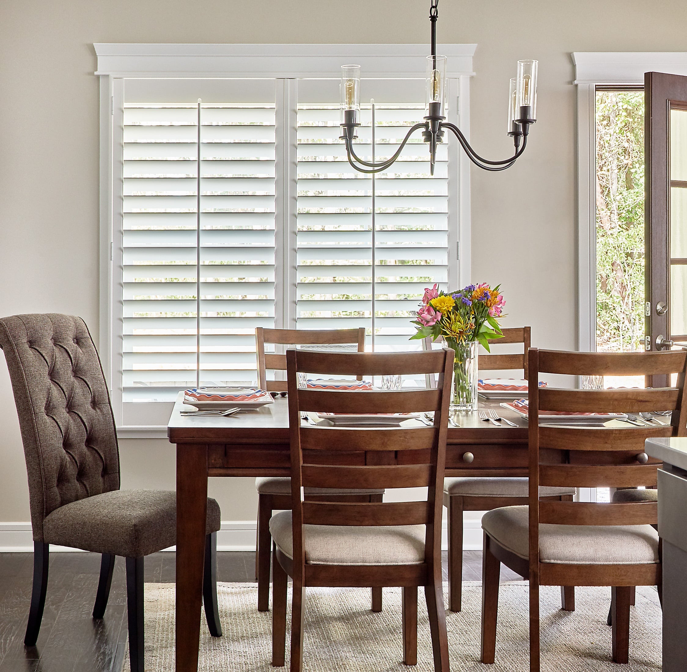 Breakfast table with white louvered shutters on the window