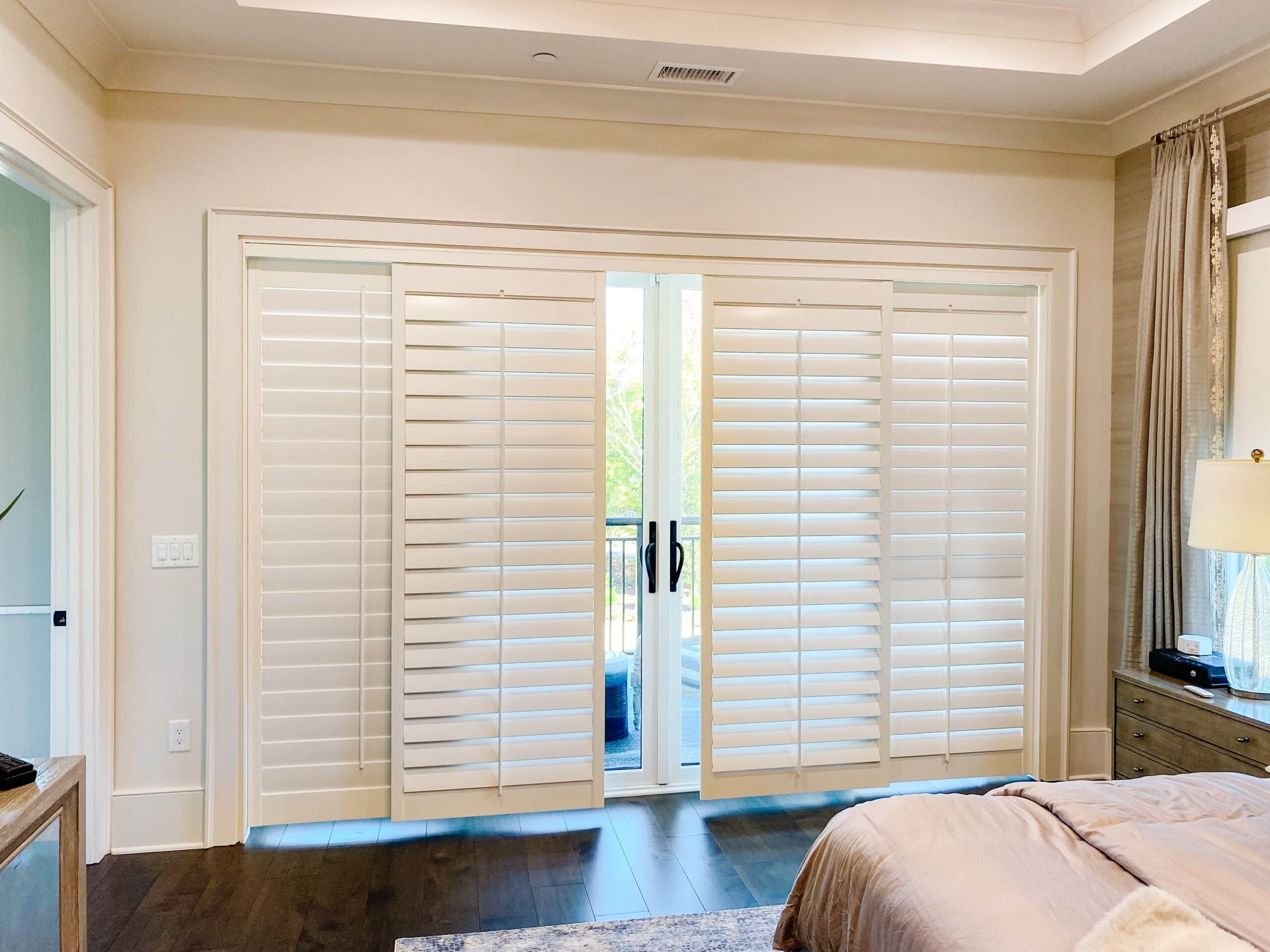 A 4 panel sliding shutter covers a sliding glass door