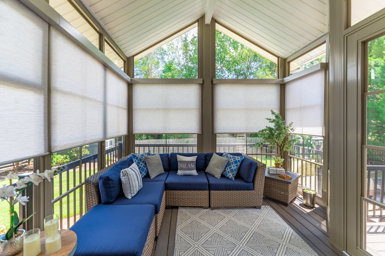 Grey textural roller shades on an enclosed patio