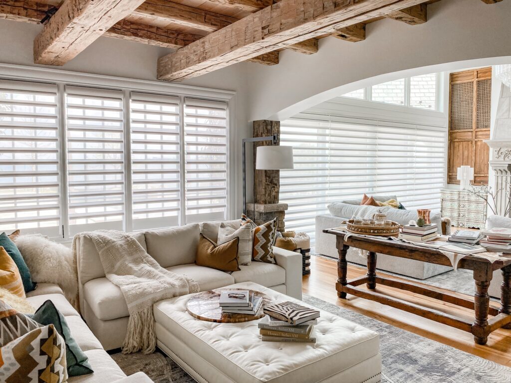 Living room with Pirouette window shadings filtering natural light in a soft, coastal-inspired interior