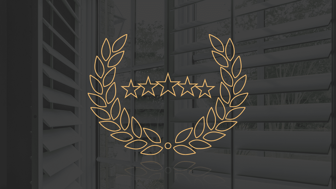 A line-drawn warranty emblem from A Shade Above against the backdrop of a dark plantation shutter