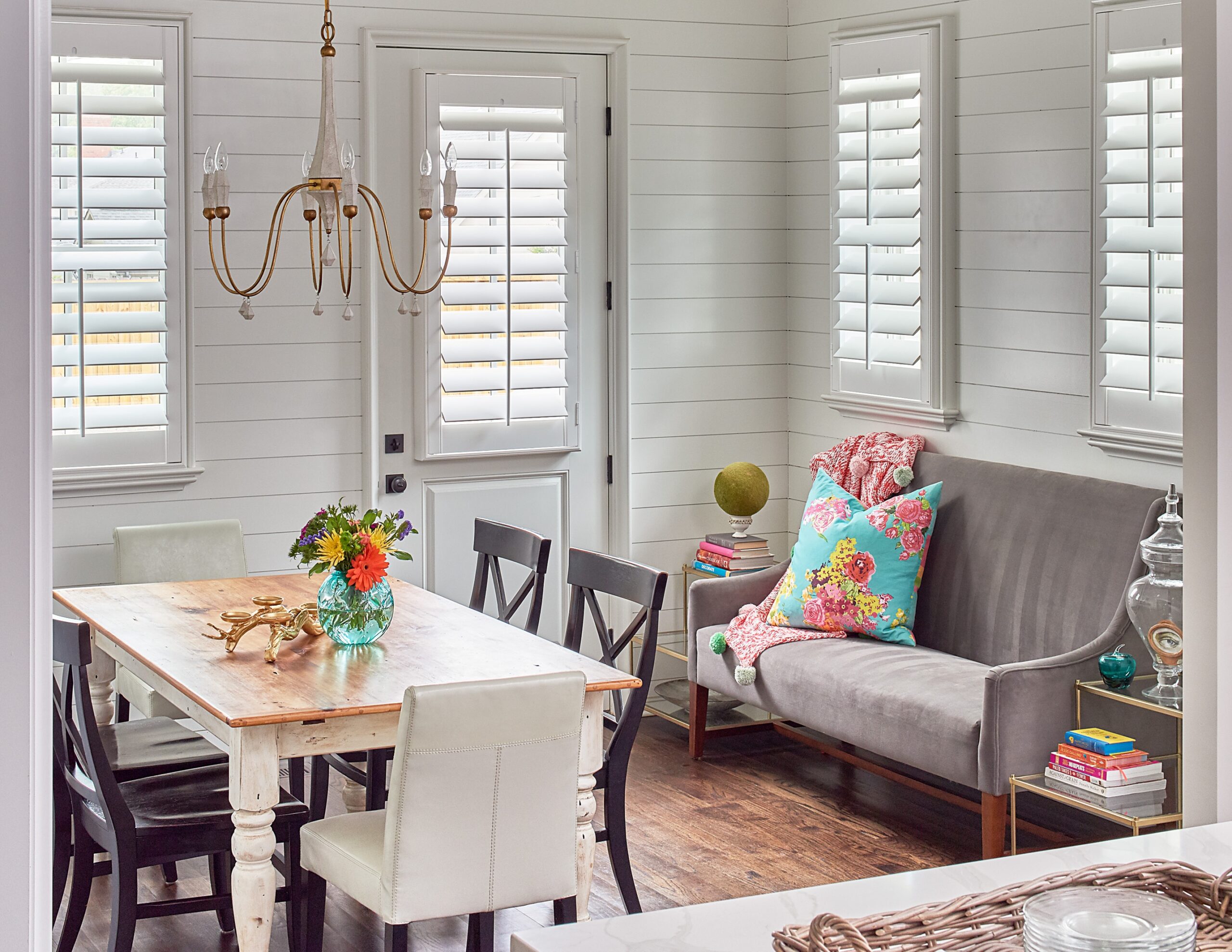 Breakfast nook featuring shutters on windows and the central door