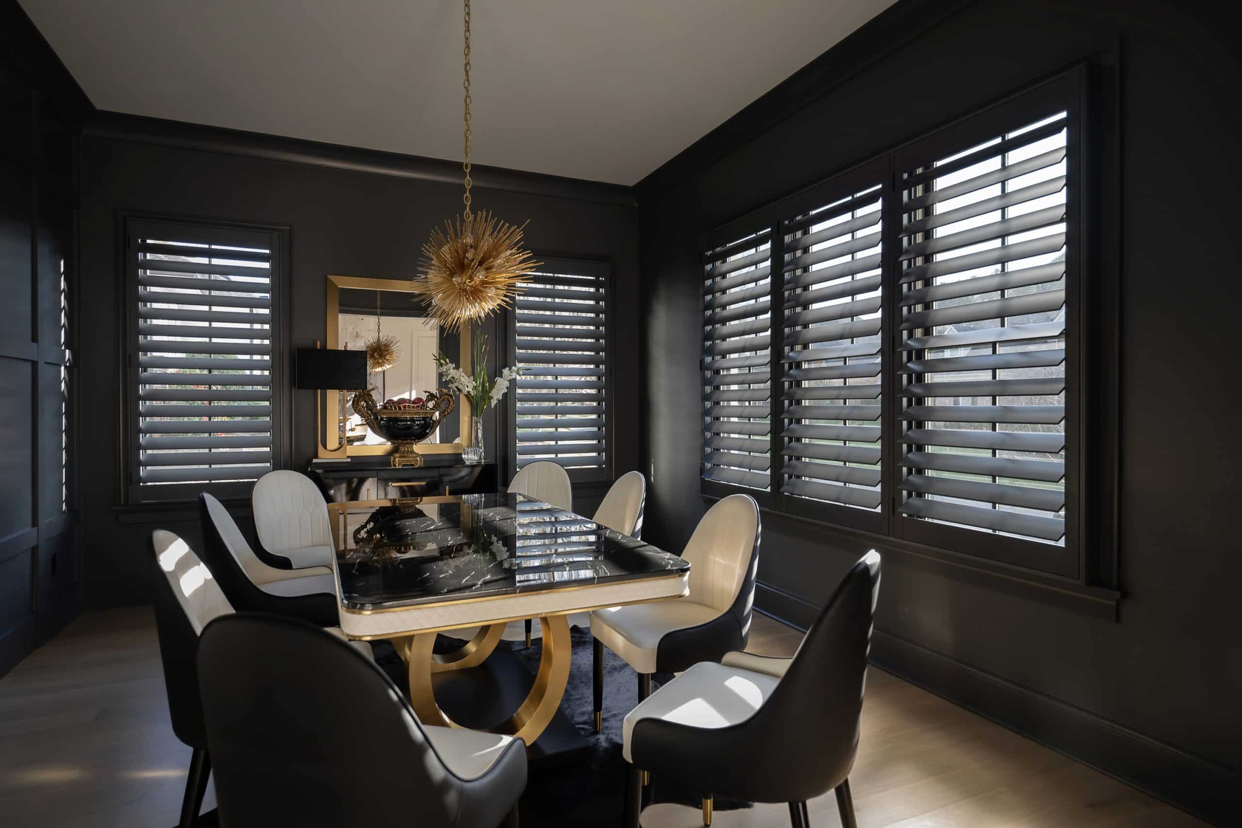 Custom dark blue shutters surround a modern dining table