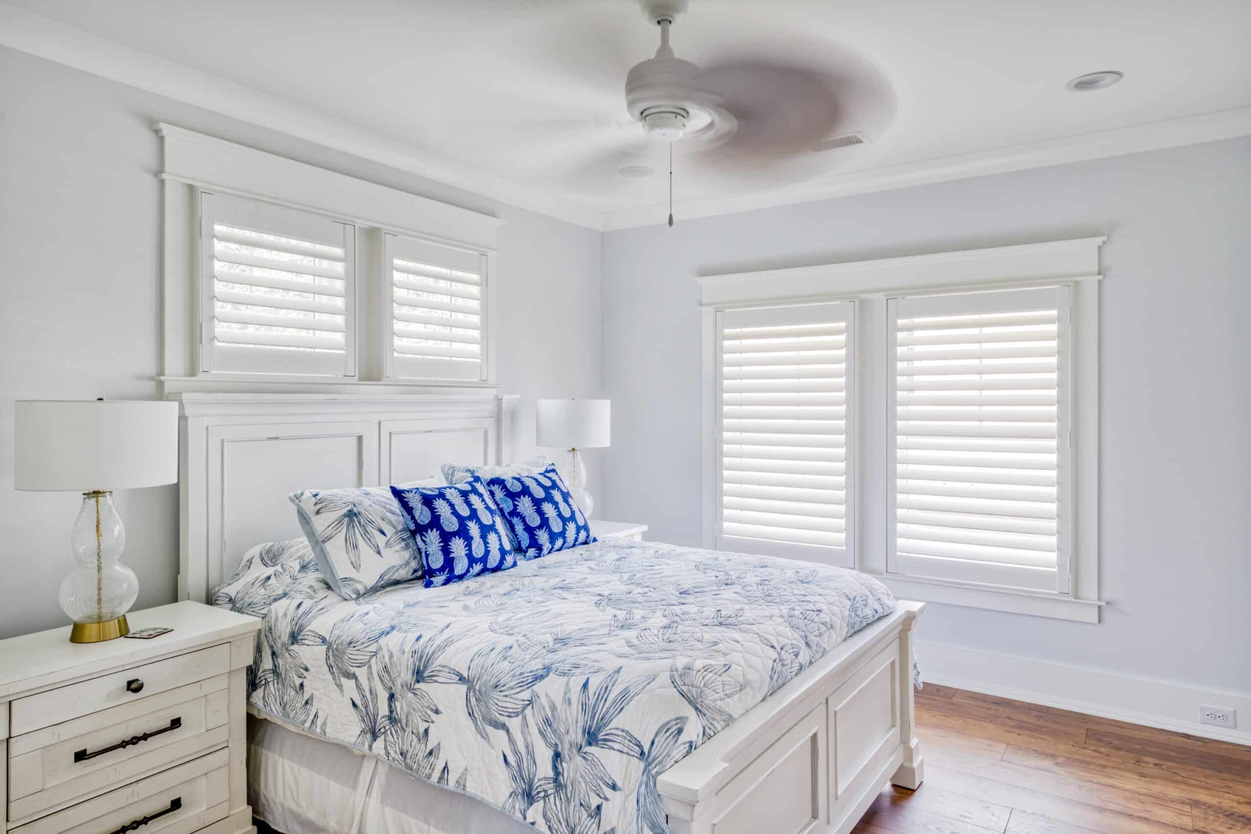 Hidden tilt plantation shutters in a well lit beach house bedroom