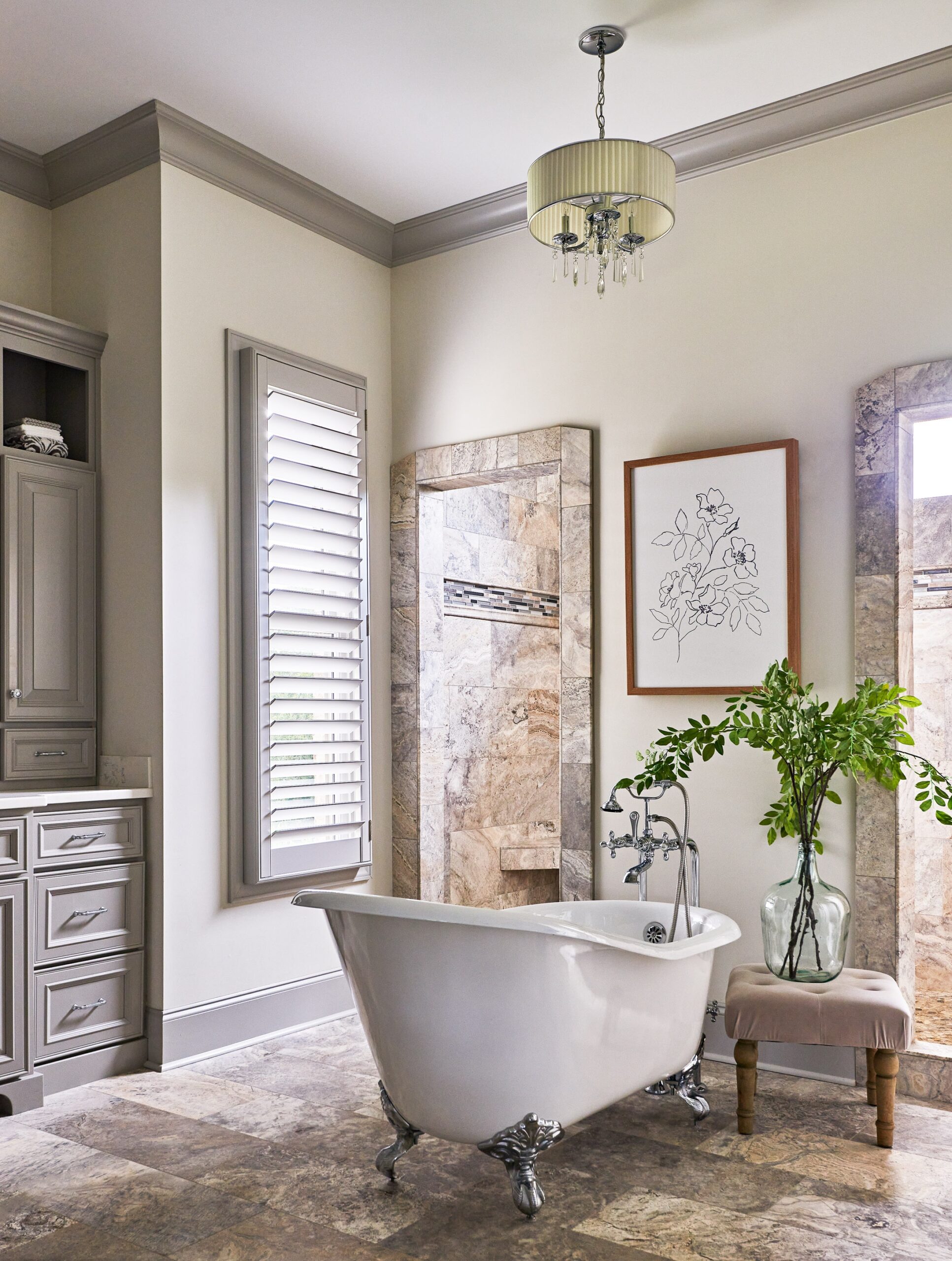 Bathroom with a large clawfoot tub and a grey shutter on the window