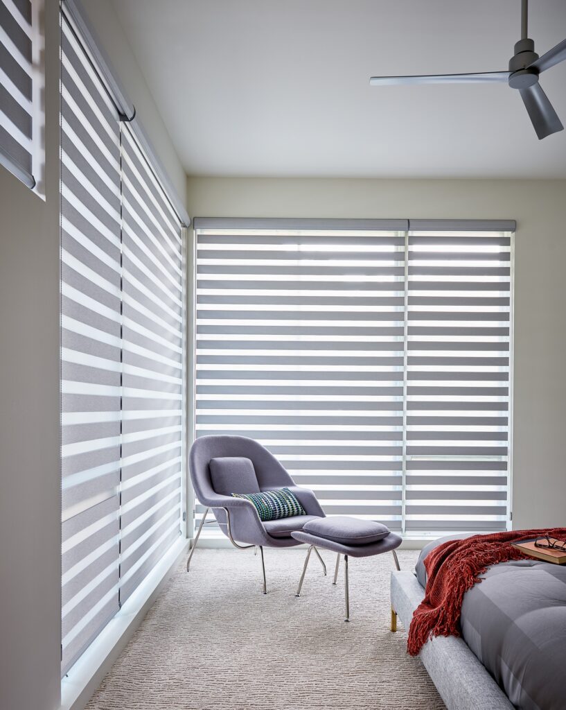Grey banded band shades in a modern bedroom with a bed
