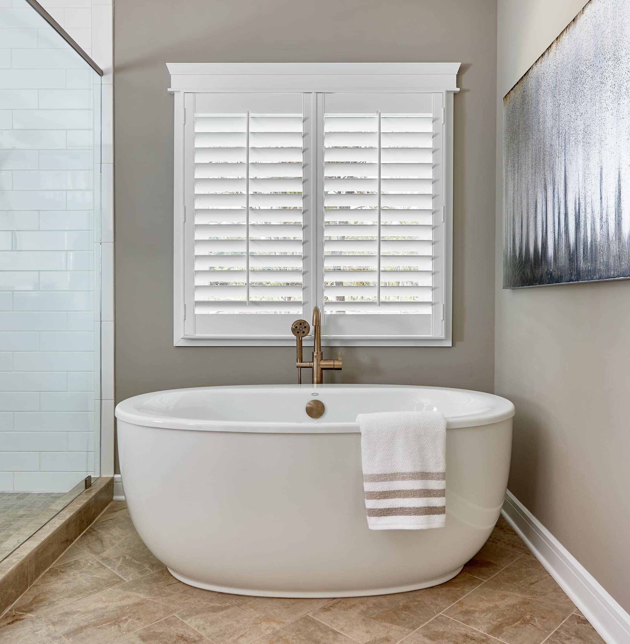 Modern bathroom with interior window shutters above a floating tub