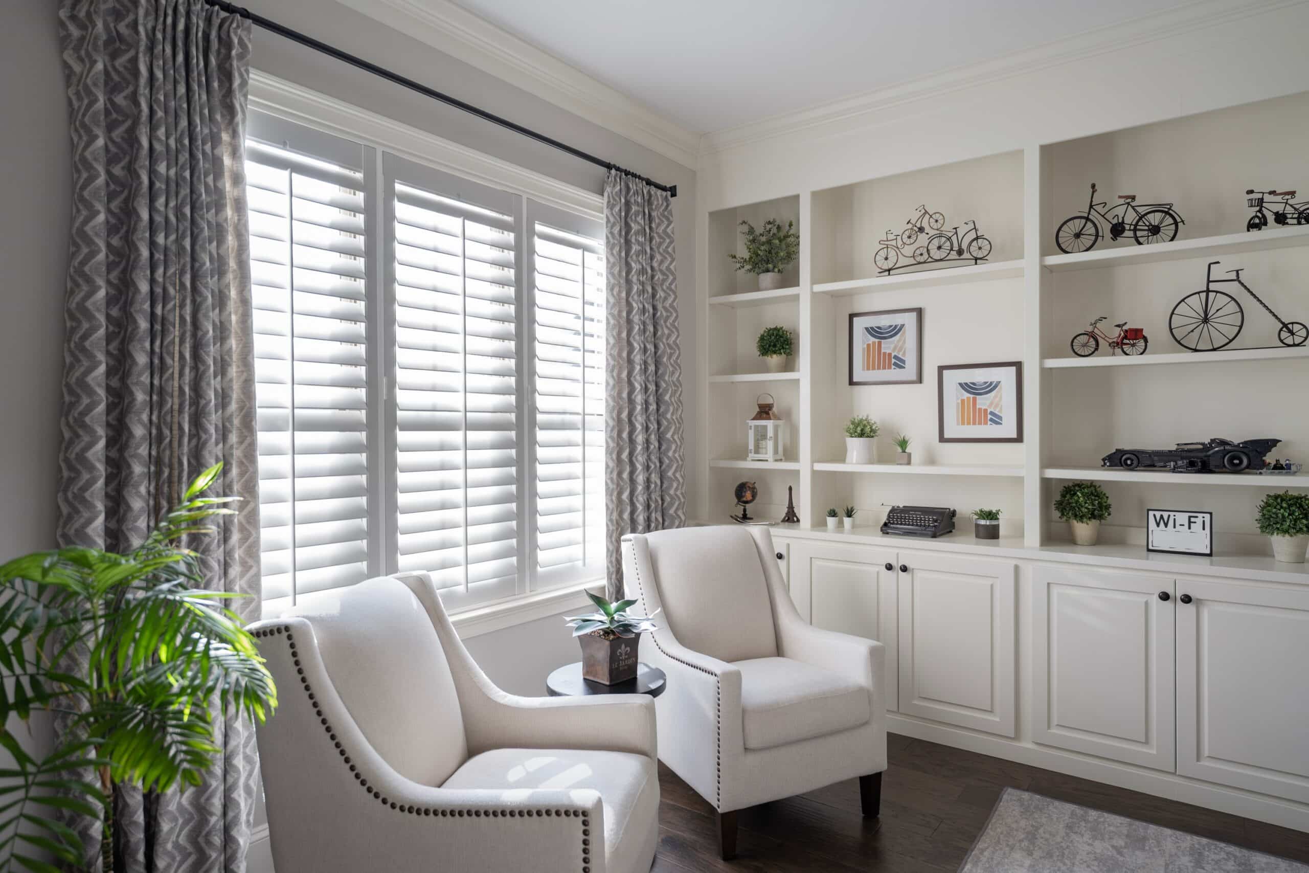 An office with sitting chairs and a triple wood shutter