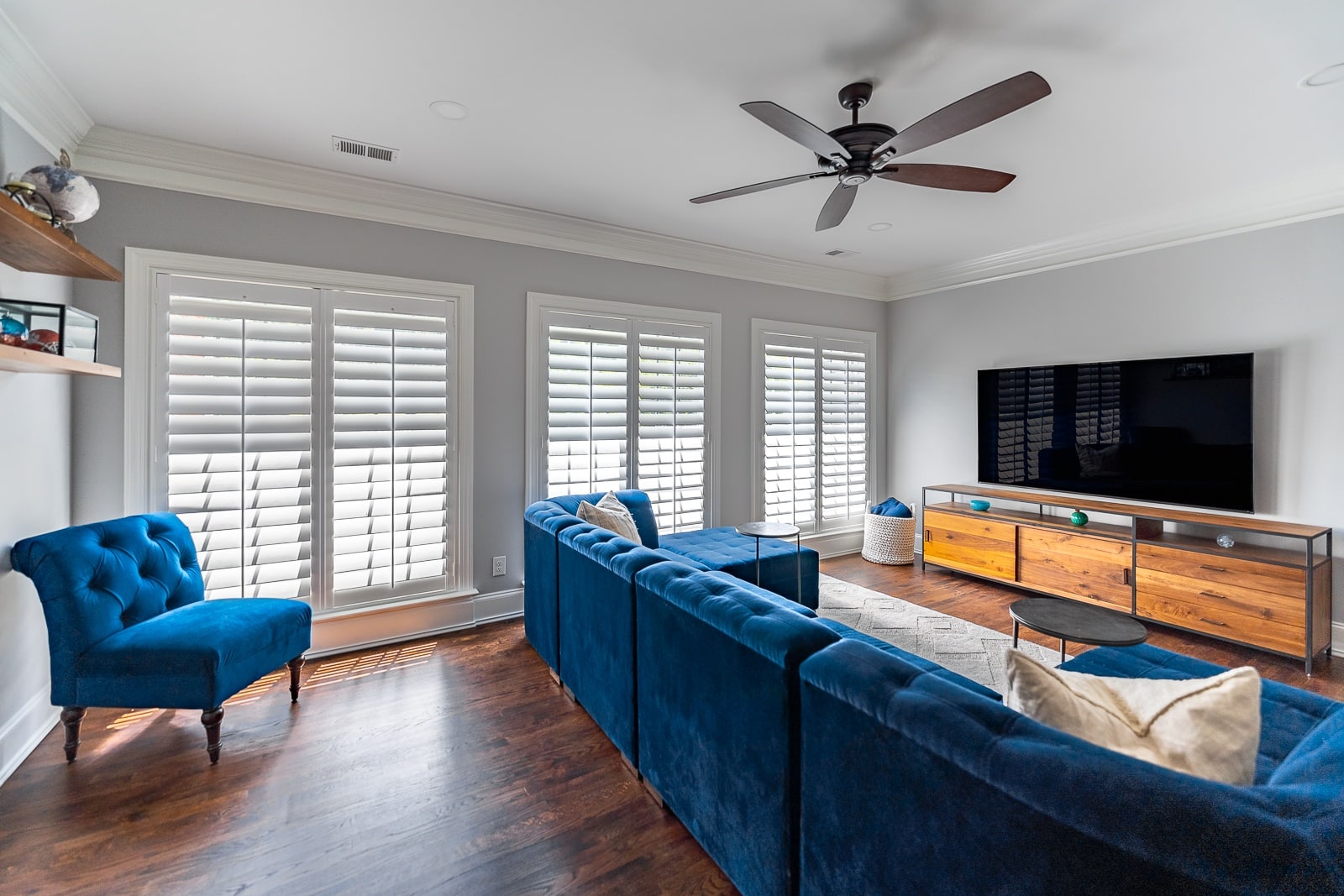 Large bank of wood shutters in a media room