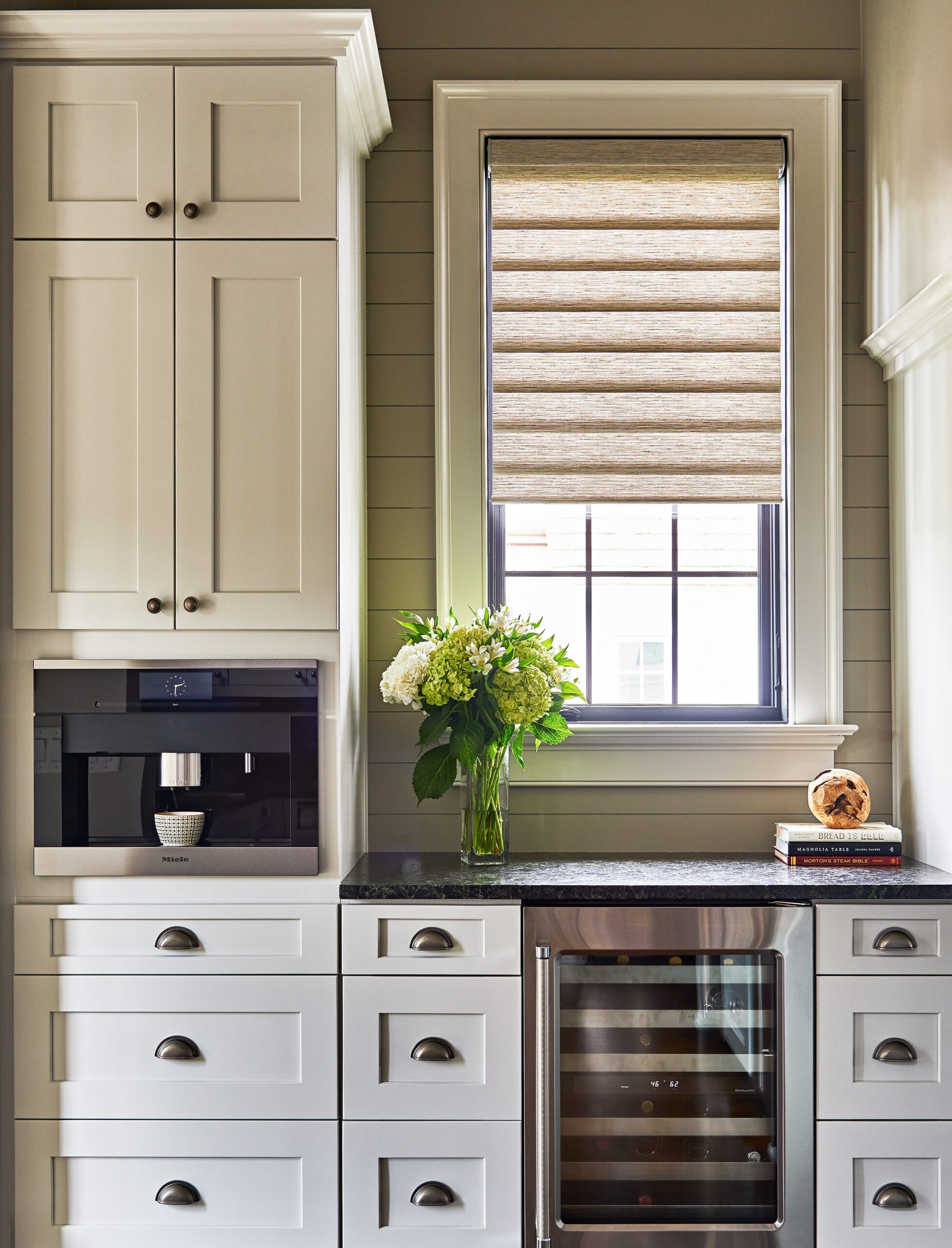 light filtering roman shade in a corner of a modern kitchen