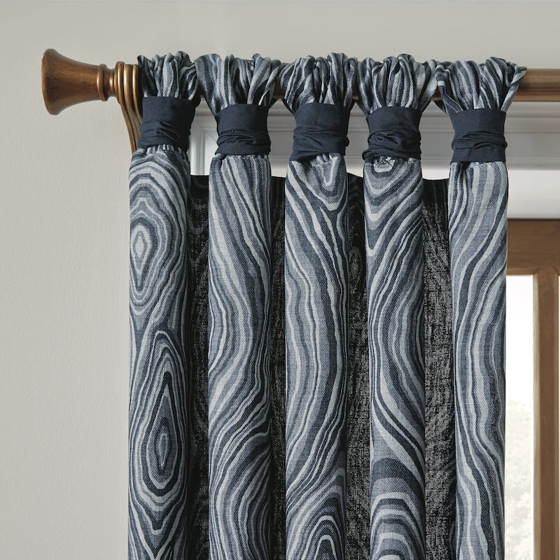 Blue gathered tab curtains on bronze hardware