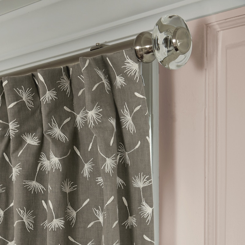 Light gray printed drapery and finial detail photo