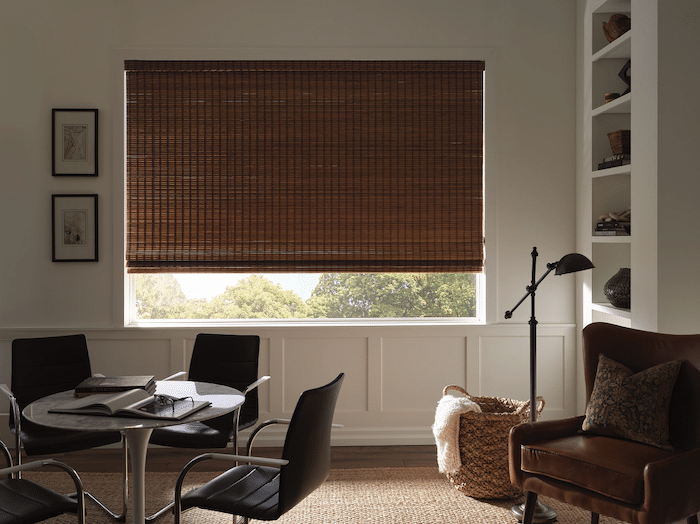 An opaque woven wood shade hanging in a farmhouse modern office