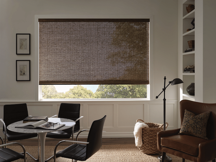 A semi-opaque woven wood shade hanging in a farmhouse modern office