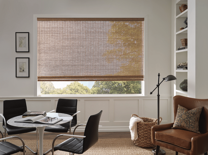 A sheer woven wood shade hanging in a farmhouse modern office