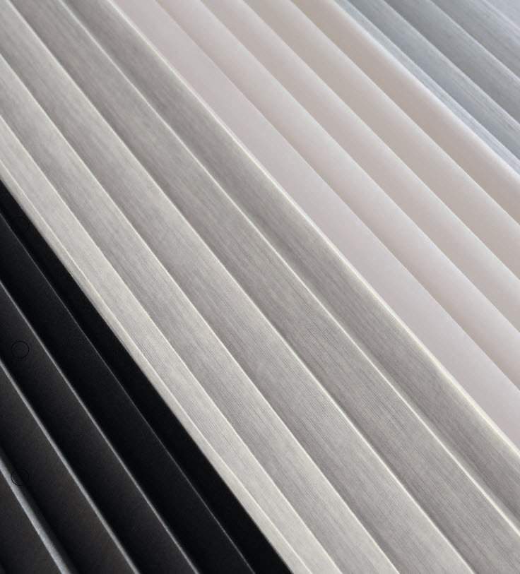 Up close view of several cellular shade pleat colors