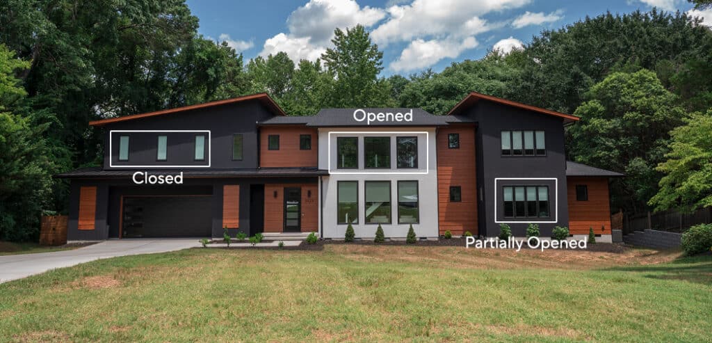 The exterior of a modern home showing roller shades at various openness levels