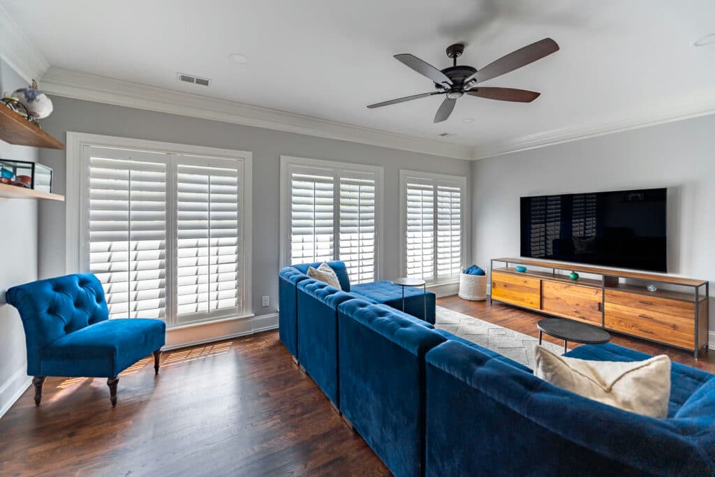 Custom wood plantation shutters on living room windows in a Wake Forest, NC home