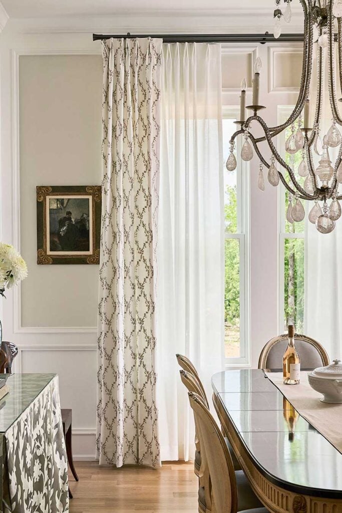 euro pleat drapery in southern coastal dining room with matte black drapery hardware