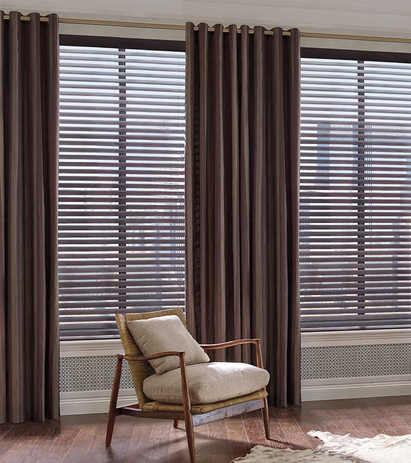 parkland-faux-wood-blinds-with-dark-contemporary-matching-curtains-hunter-douglas-a-shade-above wood blinds layered with dark brown draperies to block sunlight