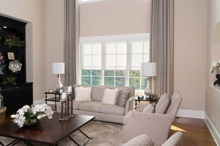 light filtering roller shades with floor-to-ceiling drapery in oversized living room