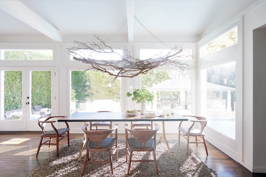 Dining room with uncovered windows exposed to damaging UV rays and excessive sunlight