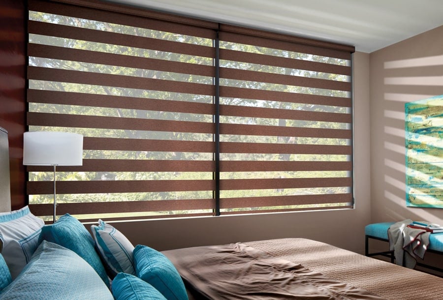 Designer Banded Shades lowered to reveal outdoor view and soft natural light in bedroom