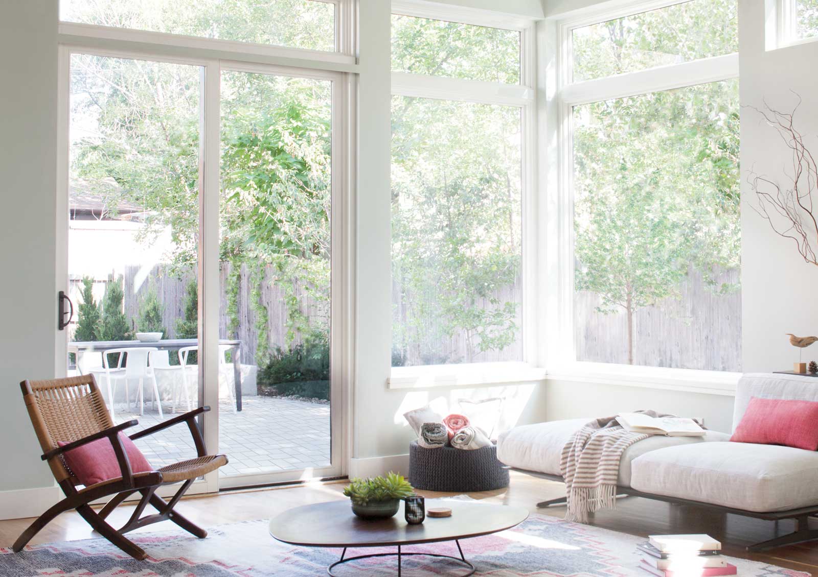 before Sonnette® cellular roller shades on large living room windows with harsh natural light