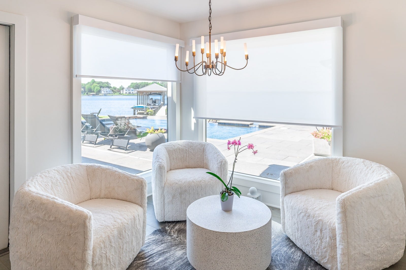 Designer roller shades creating balanced light on windows with different sun exposures in Cornelius NC home overlooking Lake Norman