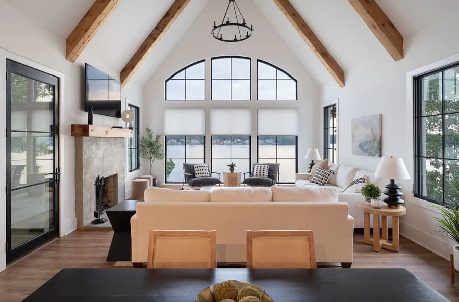Applause honeycomb shades on large living room windows overlooking the lake in a Mount Gilead home